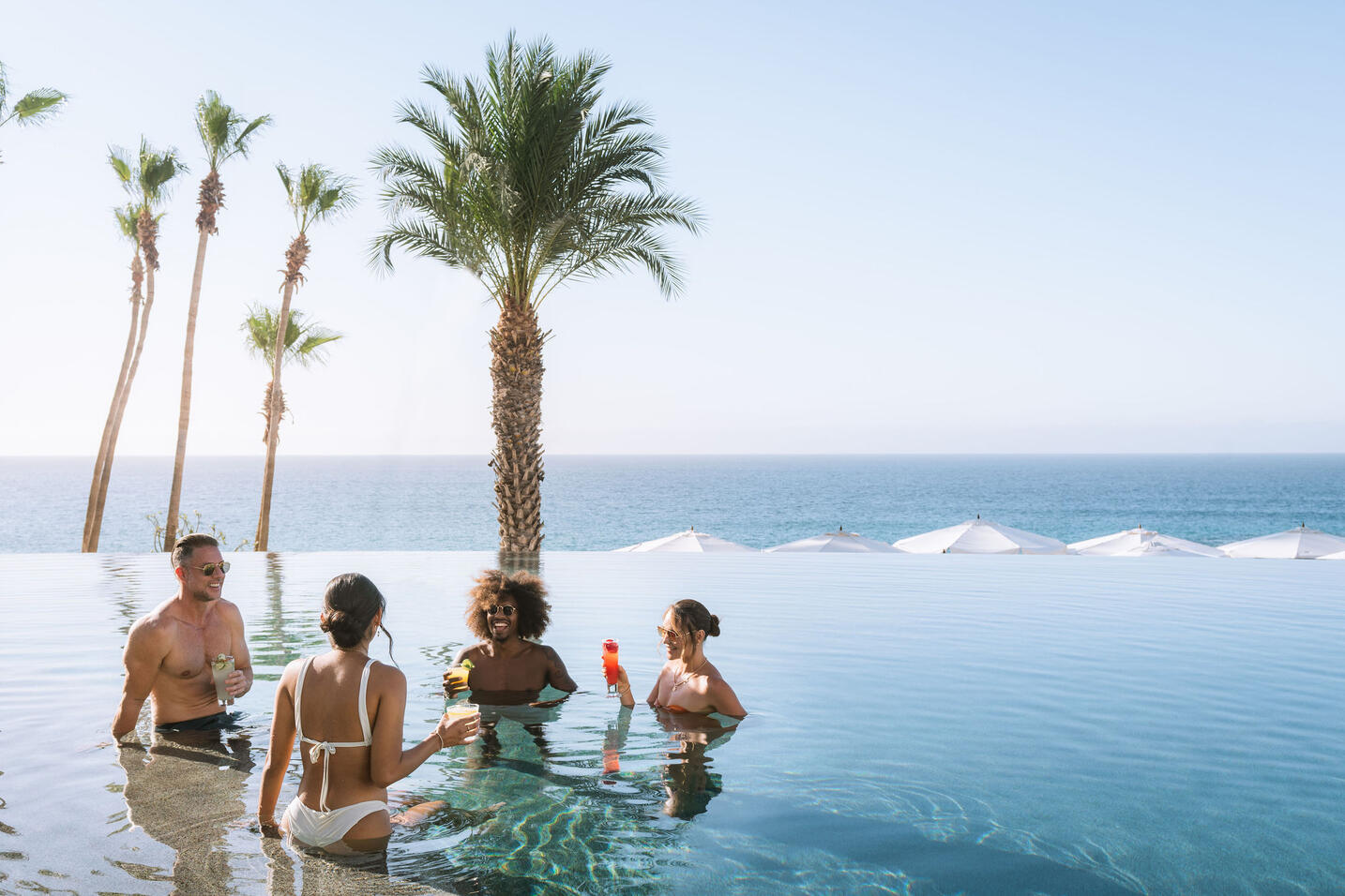 picture of people in an infinity pool with sea view