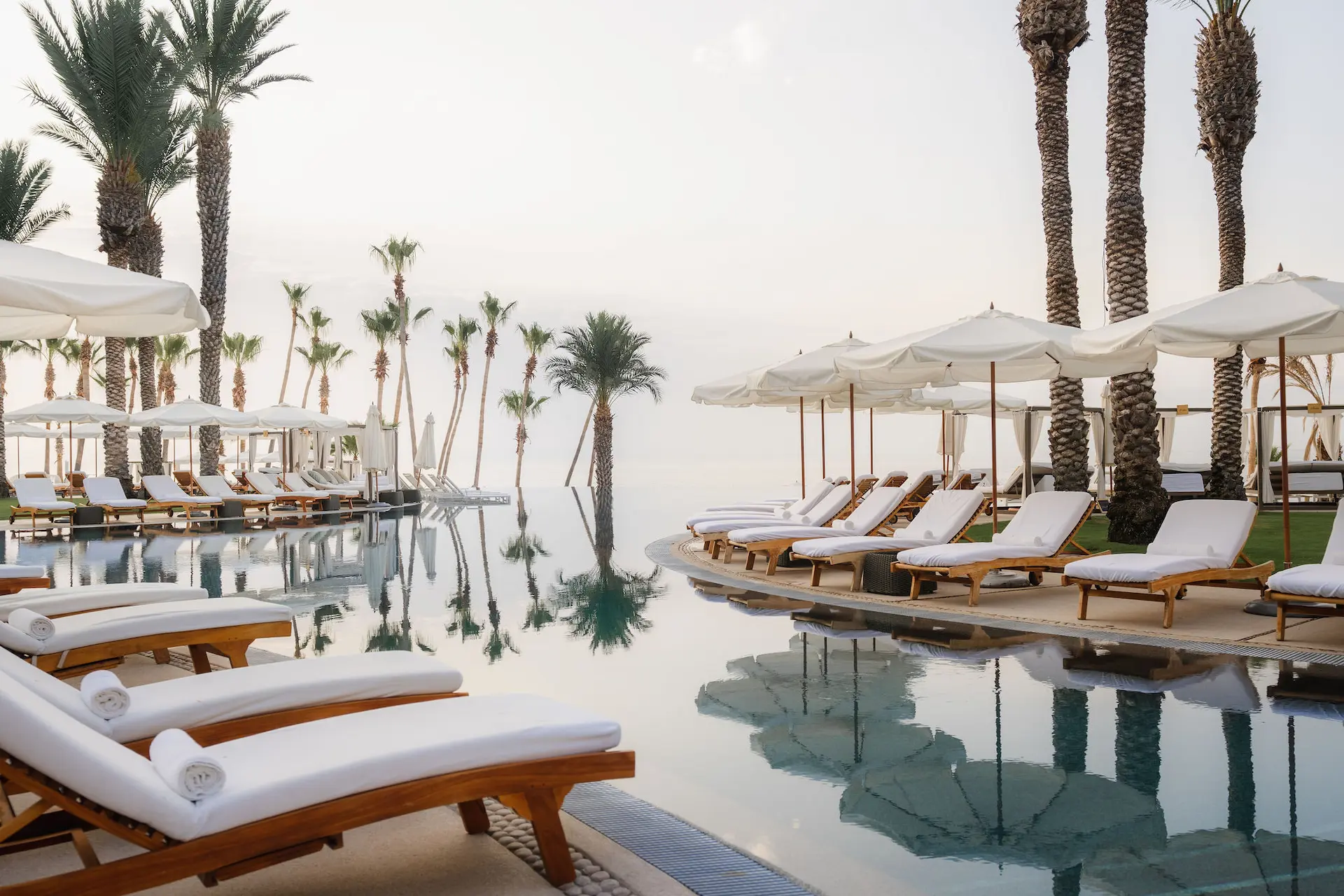 picture of the sitting area with umbrellas surrounding swimming pool area