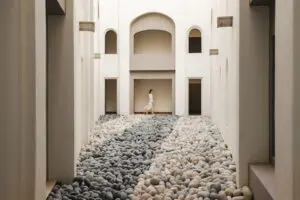 picture of a woman in white and a stone pavement