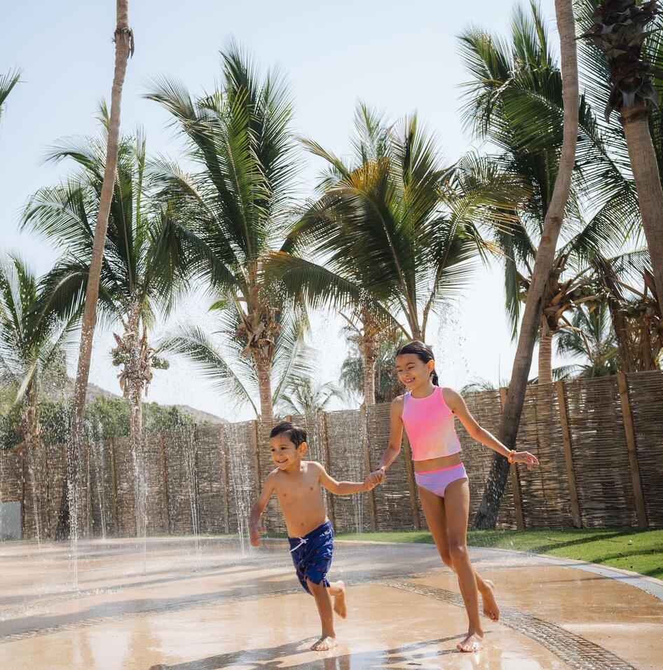 picture of two kids running near the swimming pool area