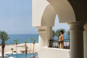 picture of a women standing in a balcony with sea view