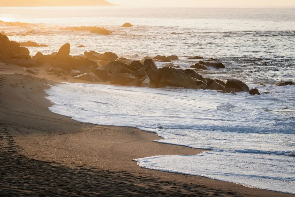 picture of sea waves and big stones on the beach