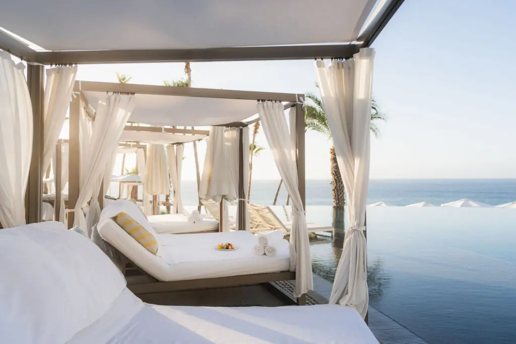 picture of infinity pool with beds in the surrounding area