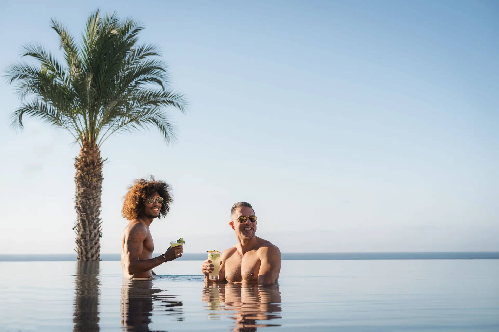 picture of two men in infinity pool