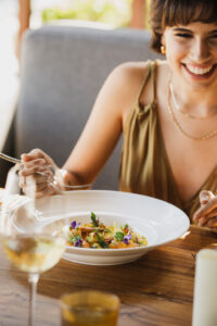 picture of a women smiling and a food item