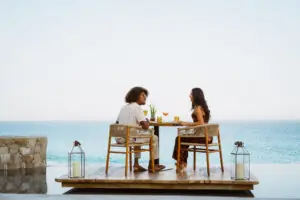 picture of two people sitting in an open restaurant with sea view