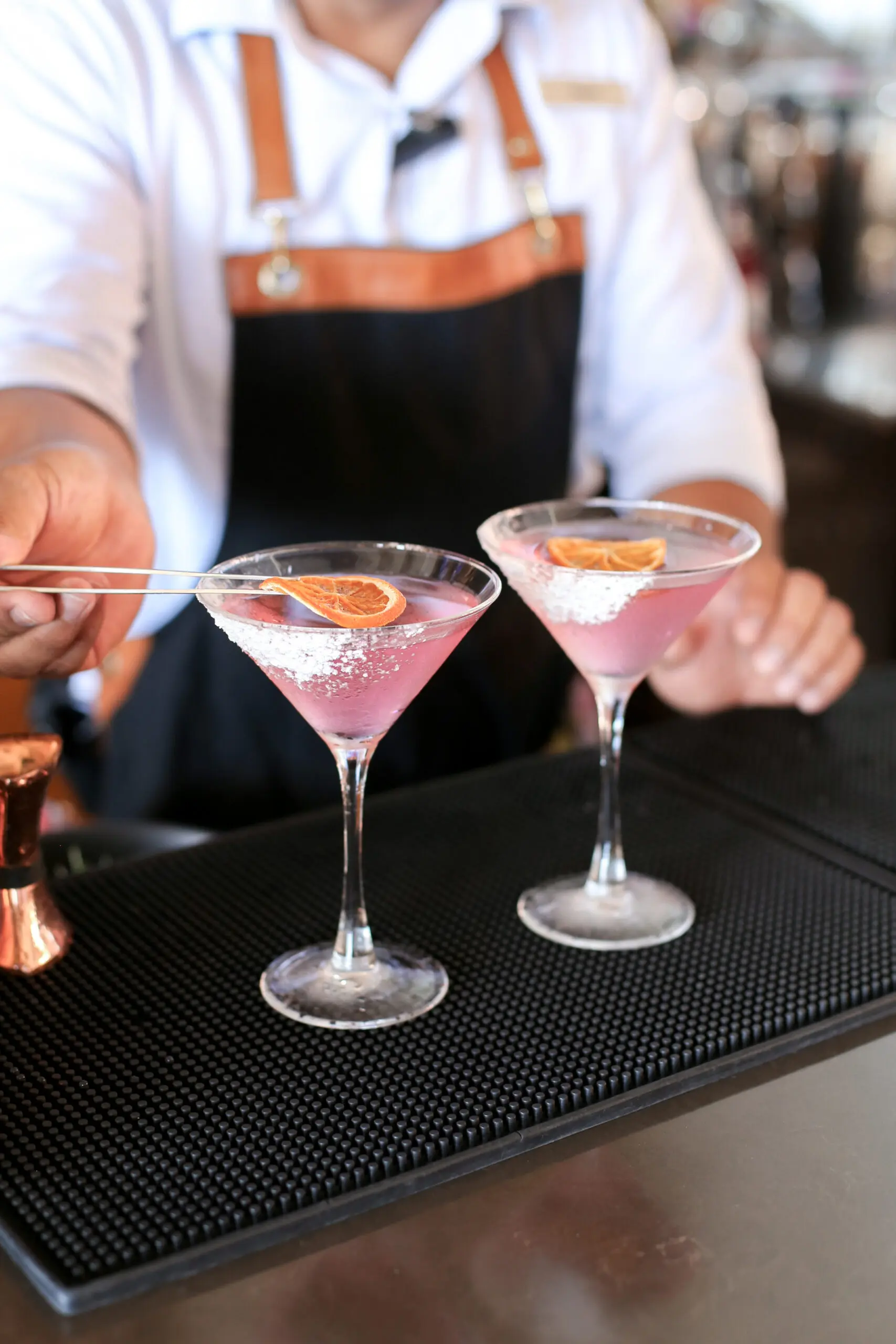 picture of chef putting orange slices in the drinks
