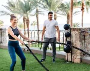 picture of two people working out in garden area